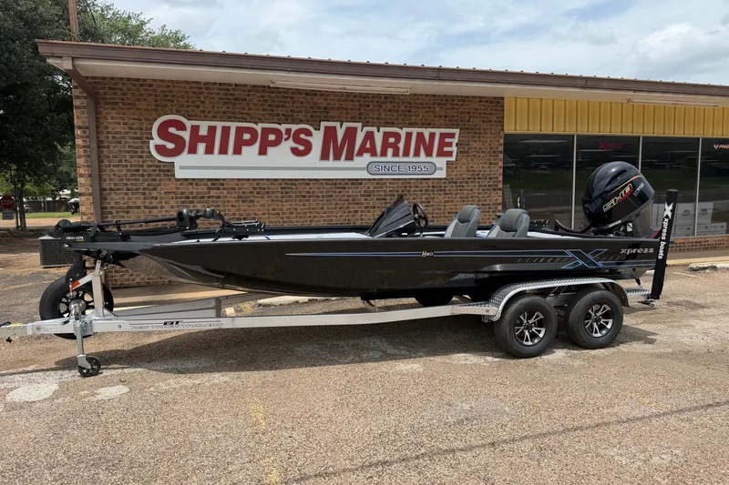 Slide: The Image of 2027 Xpress H20C Crappie boat on trailer outside Shipp's Marine store. - 1