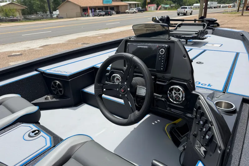 Slide: The Image of 2027 Xpress H20C Crappie boat interior with steering wheel and navigation system. - 5