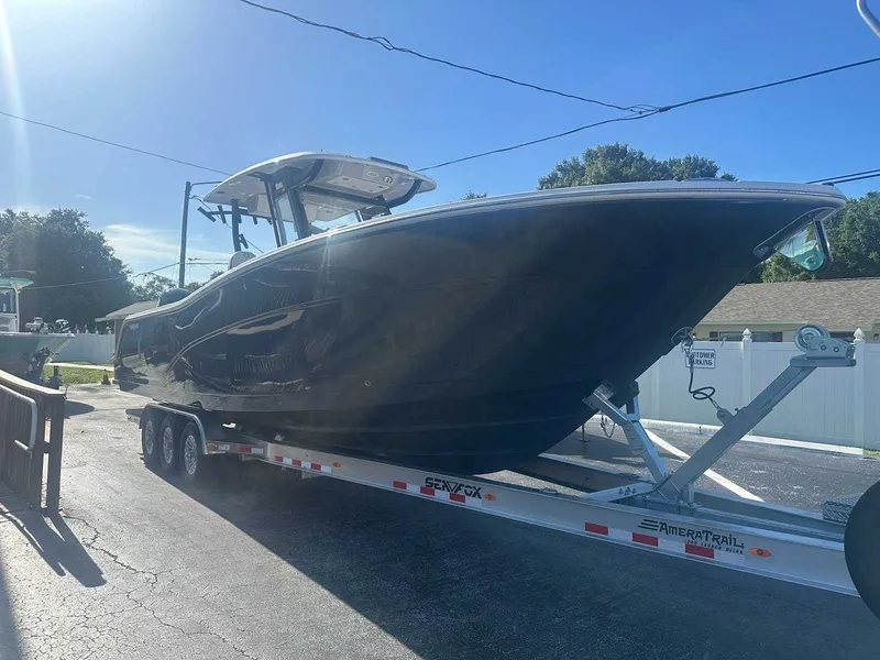Slide: The Image of A 2025 Sea Fox 328 Commander on a trailer. The boat features a sleek, modern design. - 1