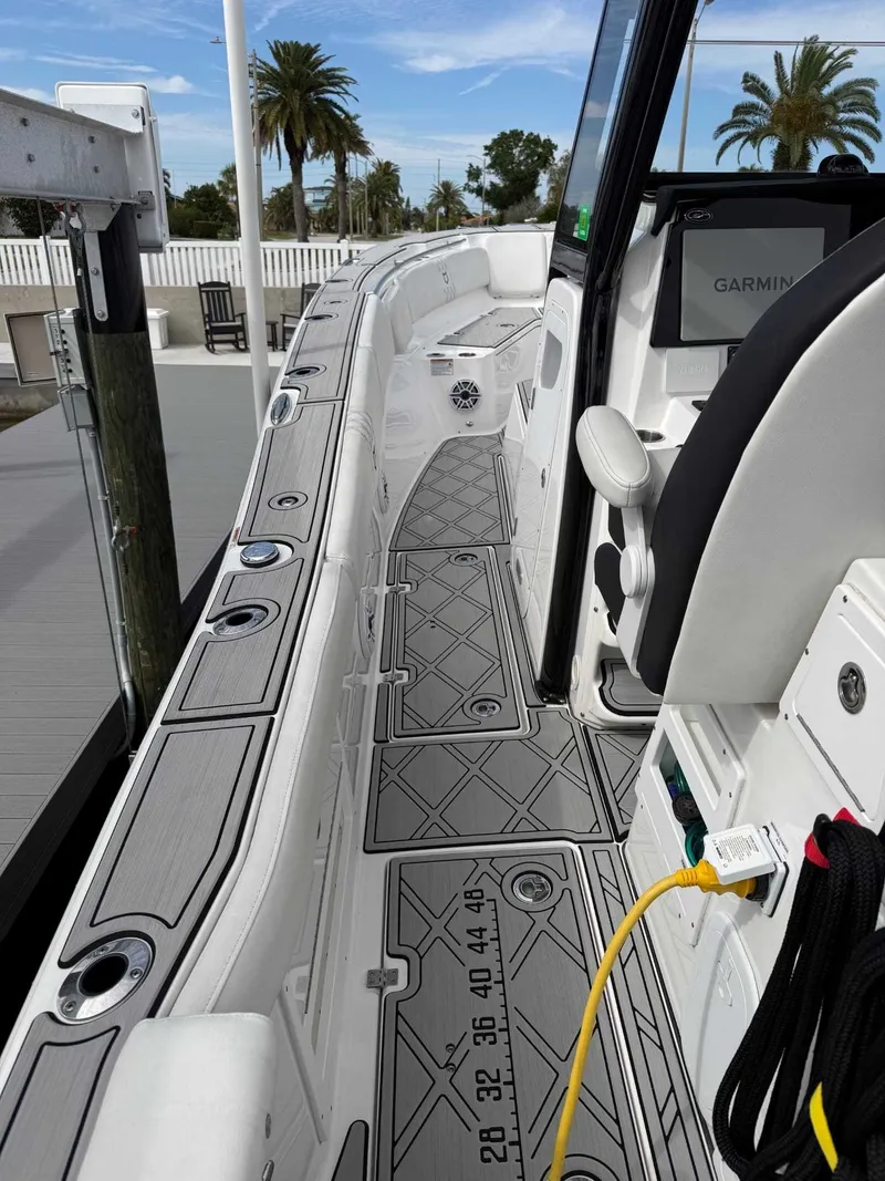 Slide: The Image of The image shows the deck of a 2025 Sea Fox 328 Commander with gray flooring and modern electronics. - 10