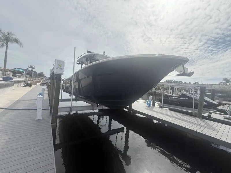 Slide: The Image of A 2025 Sea Fox 328 Commander is docked. The sky is cloudy. - 5