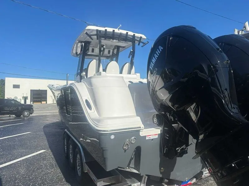 Slide: The Image of A 2025 Sea Fox 328 Commander on a trailer with two large outboard engines. - 2