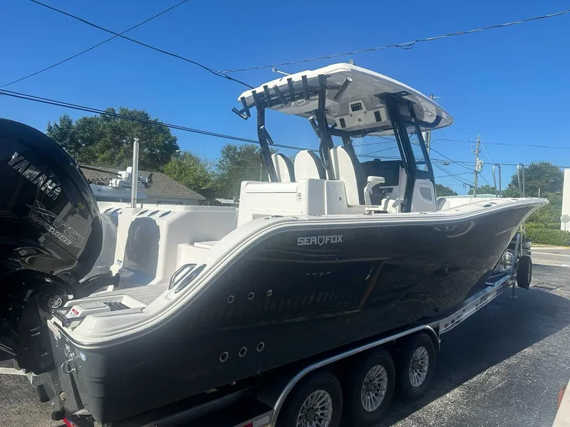 The Image of A 2025 Sea Fox 328 Commander on a trailer. It features a sleek design and twin outboard engines. - 0