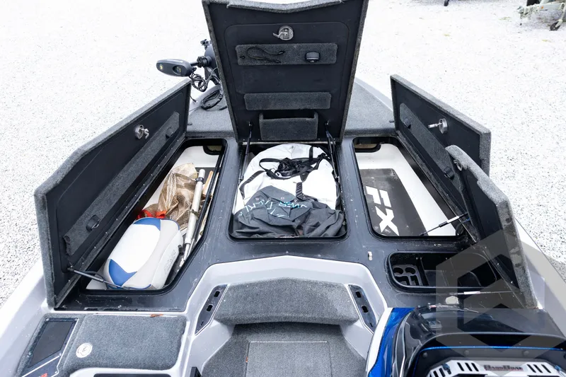 Slide: The Image of 2020 Skeeter FXR20 Limited boat storage compartments open, revealing fishing gear and equipment. - 18