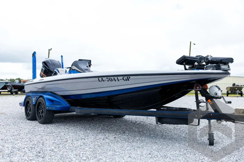 Slide: The Image of 2020 Skeeter FXR20 Limited boat on trailer, parked on gravel lot. - 3