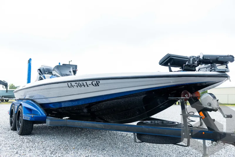 Slide: The Image of 2020 Skeeter FXR20 Limited boat on trailer, side view, parked on gravel. - 9