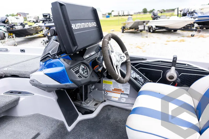 Slide: The Image of 2020 Skeeter FXR20 Limited boat cockpit with Humminbird electronics and steering wheel. - 20