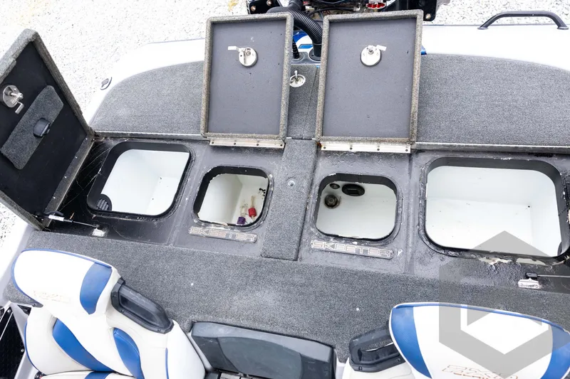 Slide: The Image of 2020 Skeeter FXR20 Limited boat storage compartments with open lids and seating area. - 26