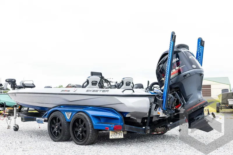 Slide: The Image of 2020 Skeeter FXR20 Limited boat with Yamaha engine on trailer, parked outdoors. - 7