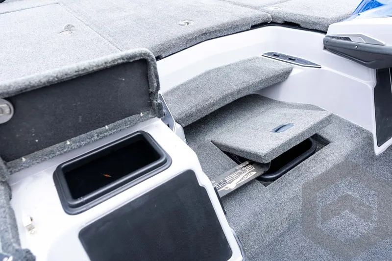 Slide: The Image of 2020 Skeeter FXR20 Limited boat interior with storage compartments and carpeted surfaces. - 19