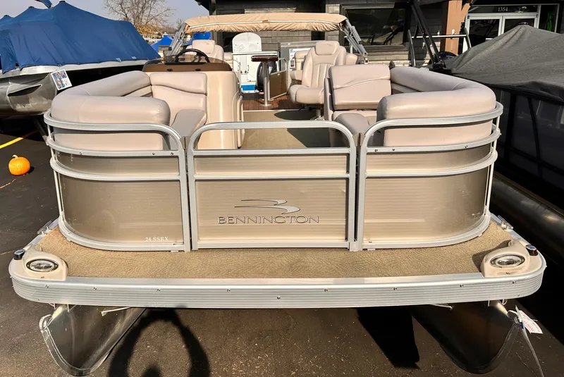 Slide: The Image of 2015 Bennington S24 pontoon boat with beige seating and silver exterior. - 7