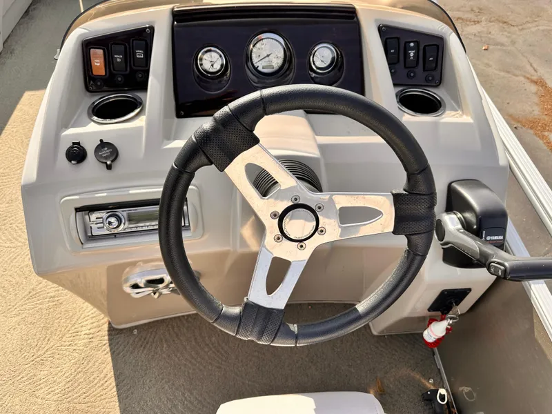 Slide: The Image of 2015 Bennington S24 boat dashboard with steering wheel and control panel. - 18
