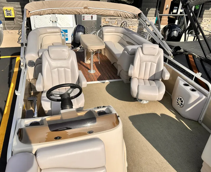 Slide: The Image of 2015 Bennington S24 pontoon boat with plush seating and steering console. - 11