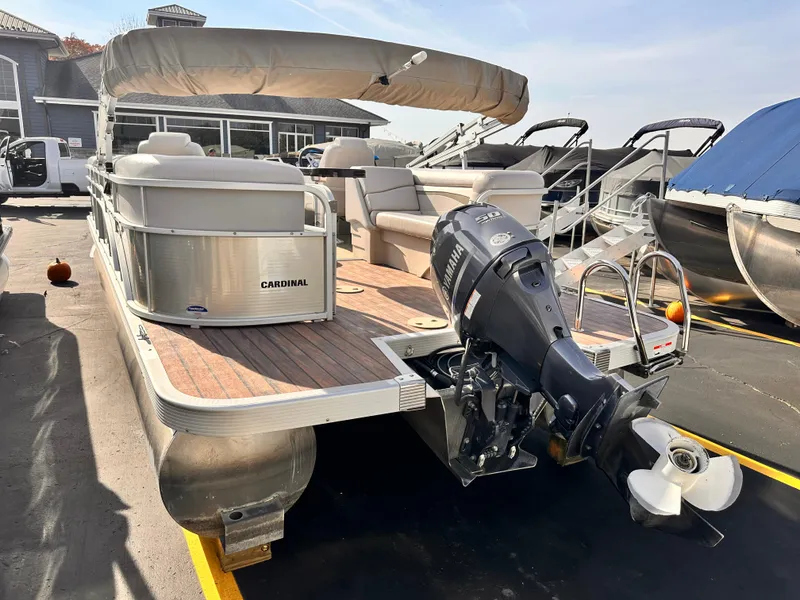 Slide: The Image of 2015 Bennington S24 pontoon boat with outboard motor, docked at marina. - 5