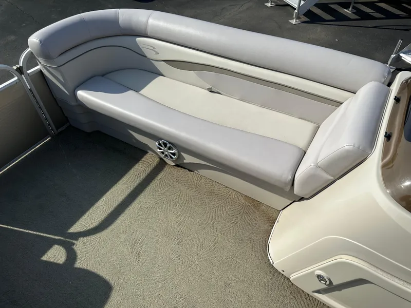 Slide: The Image of 2015 Bennington S24 boat interior with beige seating and speaker. - 9