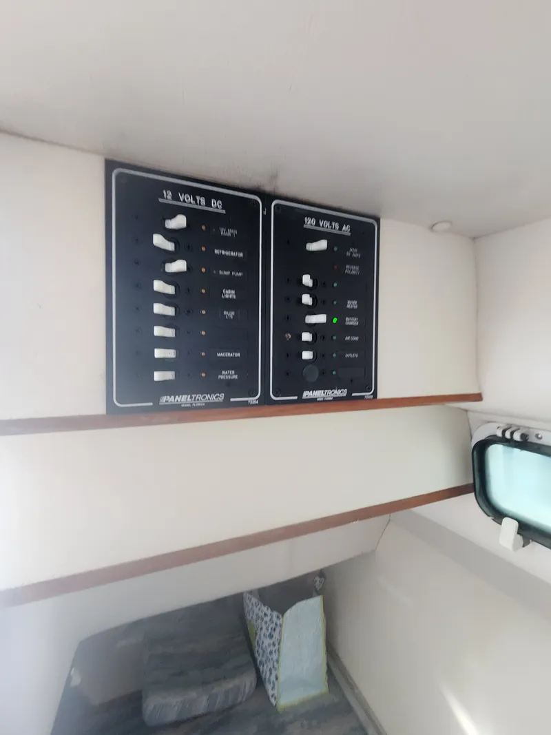 Slide: The Image of Electrical panels inside the cabin of a 1996 Albin 28 Tournament Express. - 13