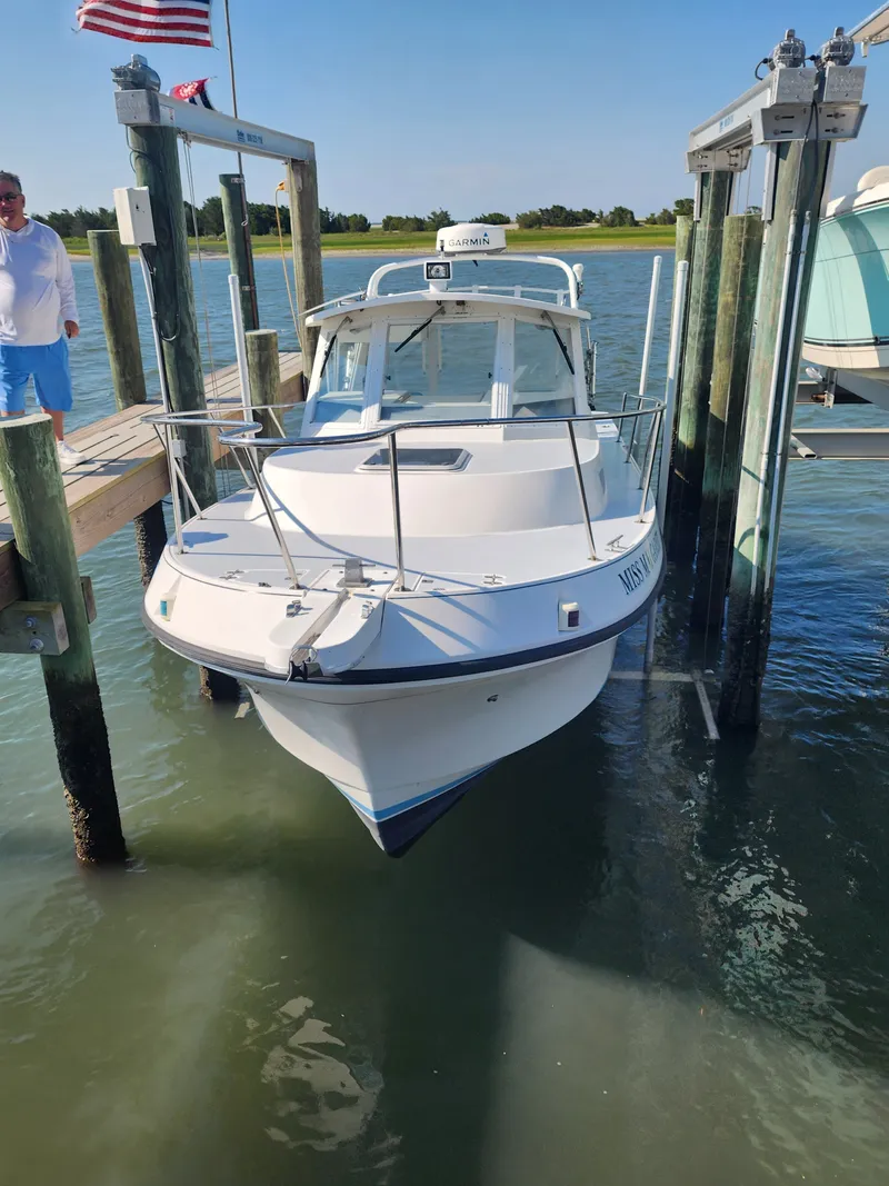 Slide: The Image of A 1996 Albin 28 Tournament Express is docked in the water. The white exterior shines. - 21