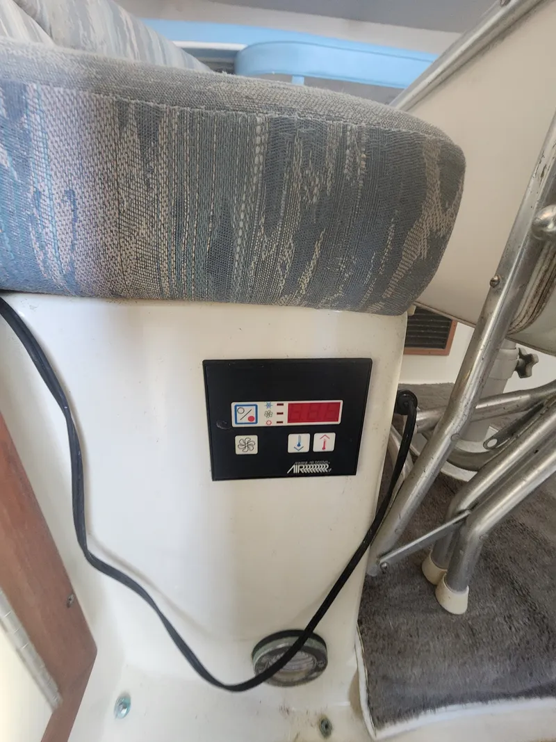 Slide: The Image of A control area with a cushioned seat and a panel featuring symbols and buttons. - 19