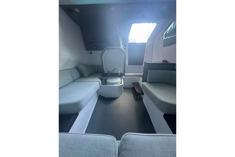 Slide: The Image of Interior of 2024 Axopar 37 Sun-Top boat, featuring modern seating and sleek design. - 8
