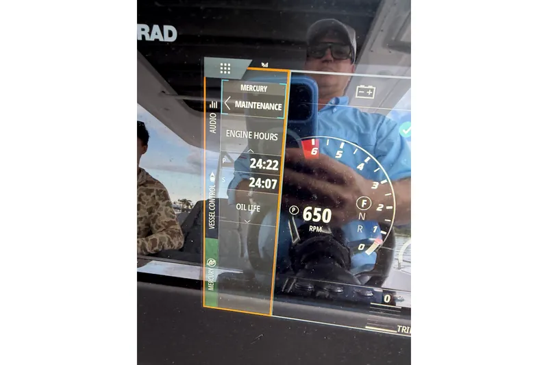 Slide: The Image of 2024 Axopar 37 Sun-Top dashboard display showing engine hours and RPM. - 9