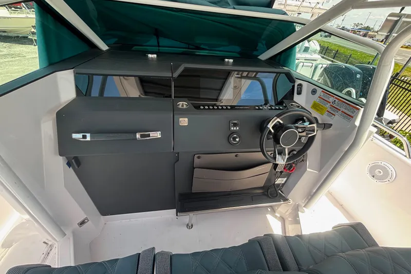 Slide: The Image of 2024 Axopar 37 Sun-Top helm with modern steering and control panel. - 6