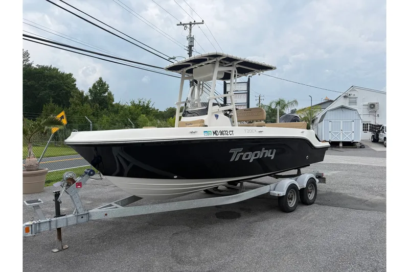 Slide: The Image of 2022 Bayliner Trophy T20CX boat on trailer, parked outdoors. - 2