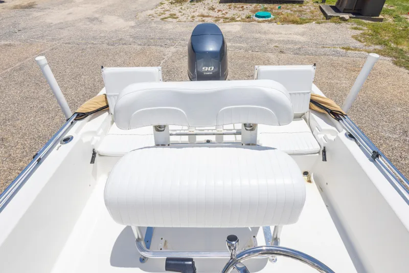 Slide: The Image of 2012 Sea Fox 180 Viper boat interior with white seating and 90 HP engine. - 28