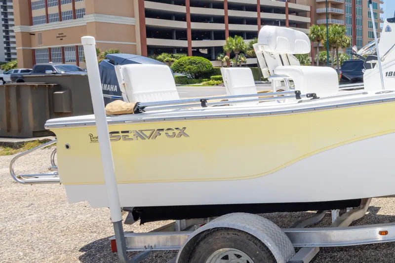 Slide: The Image of 2012 Sea Fox 180 Viper boat on trailer, parked near buildings. - 34