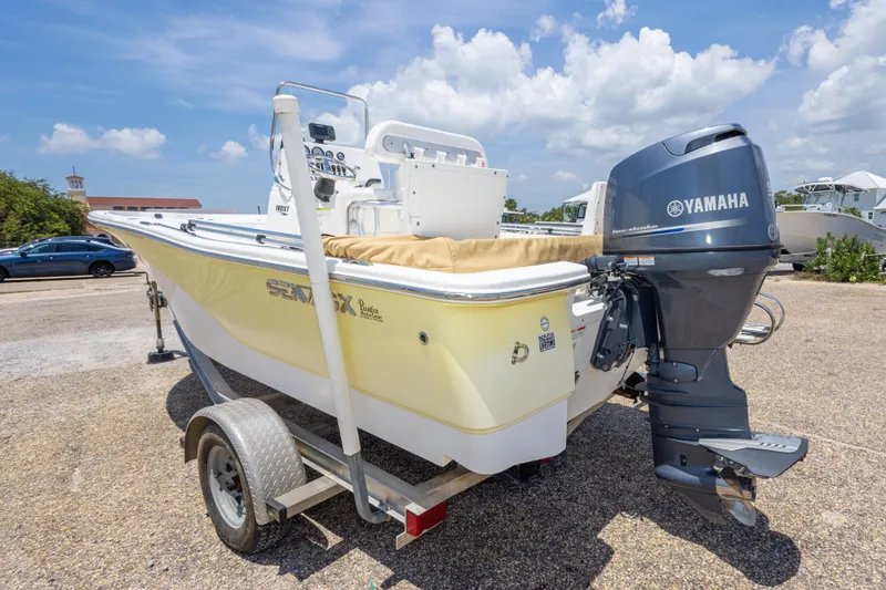 Slide: The Image of 2012 Sea Fox 180 Viper boat with Yamaha outboard motor on trailer, parked outdoors. - 13