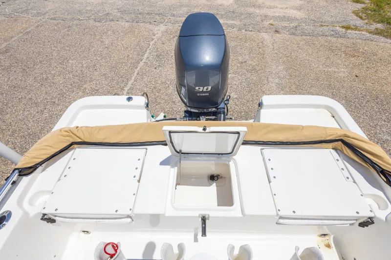 Slide: The Image of 2012 Sea Fox 180 Viper boat with Yamaha 90 engine, featuring storage compartments. - 30