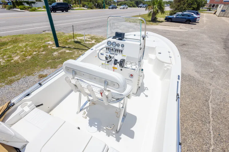 Slide: The Image of 2012 Sea Fox 180 Viper boat with console and seating, parked near a road. - 19