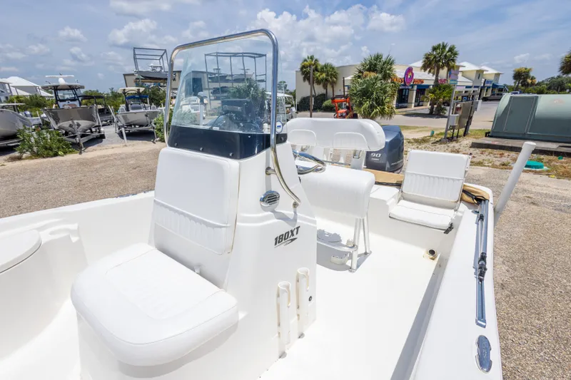 Slide: The Image of 2012 Sea Fox 180 Viper boat with white seating and console, parked outdoors. - 26