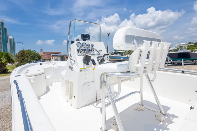 Slide: The Image of 2012 Sea Fox 180 Viper boat interior with steering console and seating under a clear sky. - 18
