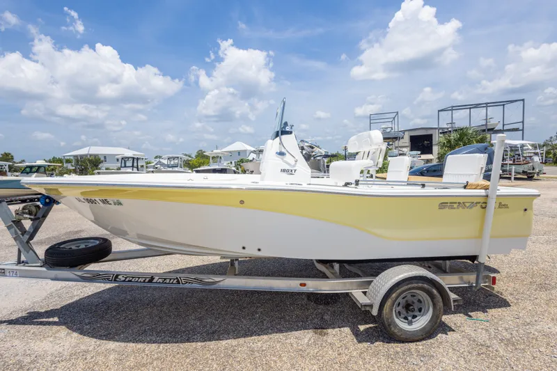 Slide: The Image of 2012 Sea Fox 180 Viper boat on trailer under a bright blue sky. - 14