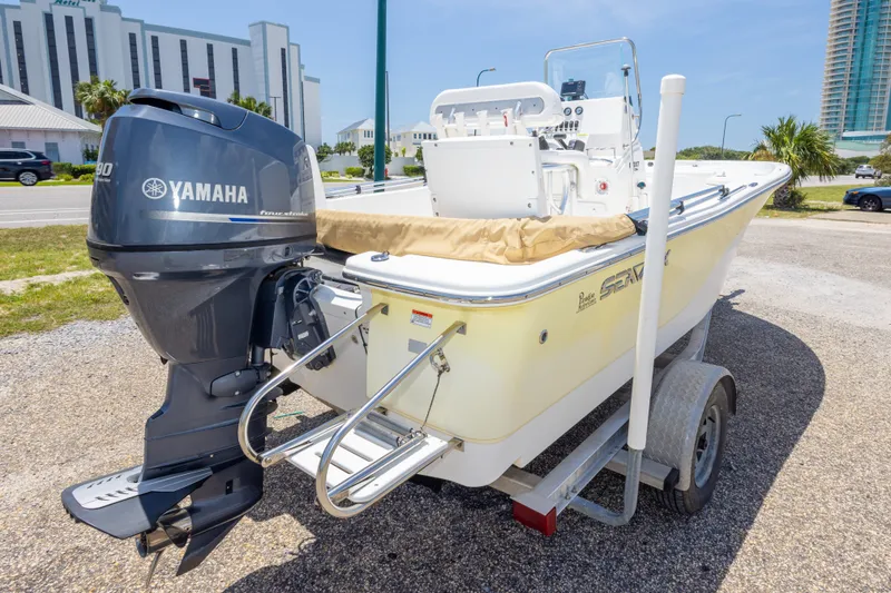 Slide: The Image of 2012 Sea Fox 180 Viper boat with Yamaha engine on trailer, parked near buildings. - 11