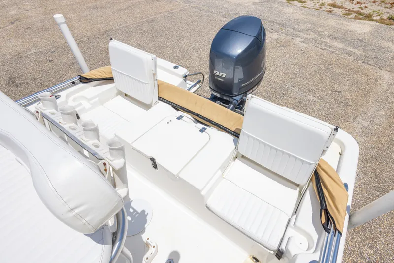 Slide: The Image of 2012 Sea Fox 180 Viper boat interior with Yamaha 90 engine, featuring white seating and rod holders. - 33