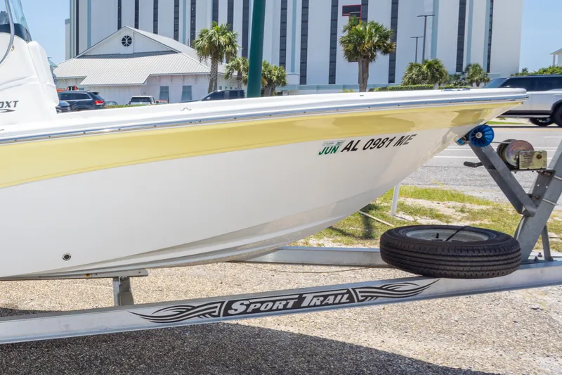 Slide: The Image of 2012 Sea Fox 180 Viper boat on Sport Trail trailer, parked near buildings and palm trees. - 35