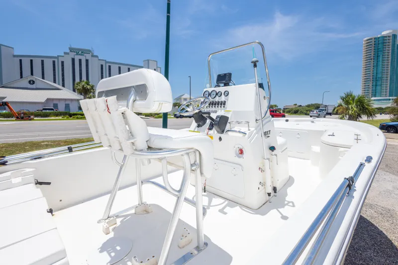 Slide: The Image of 2012 Sea Fox 180 Viper boat with console and seating, parked near buildings under clear sky. - 17