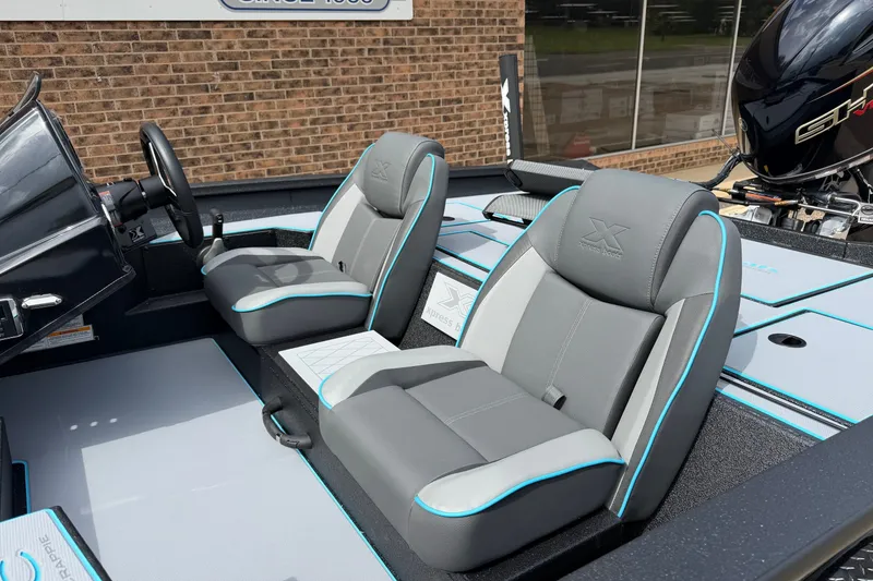 Slide: The Image of 2027 Xpress H18C Crappie boat interior with gray and blue seating. - 5