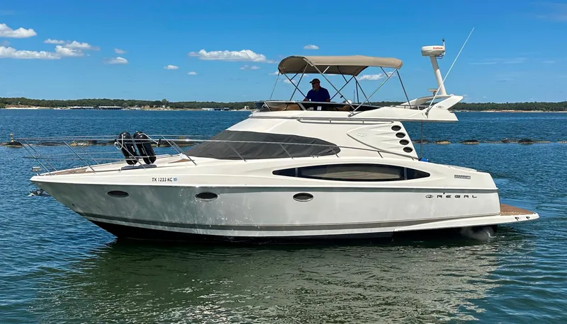 Slide: The Image of 2001 Regal Commodore 3780 yacht cruising on a sunny day. - 2