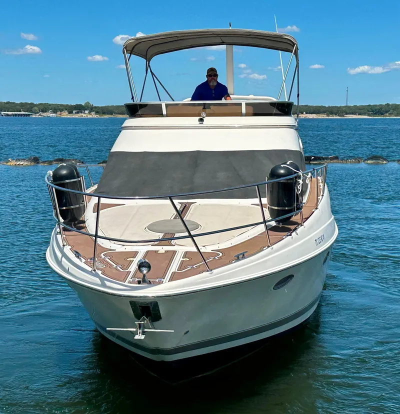 Slide: The Image of 2001 Regal Commodore 3780 yacht on calm water, clear sky background. - 4