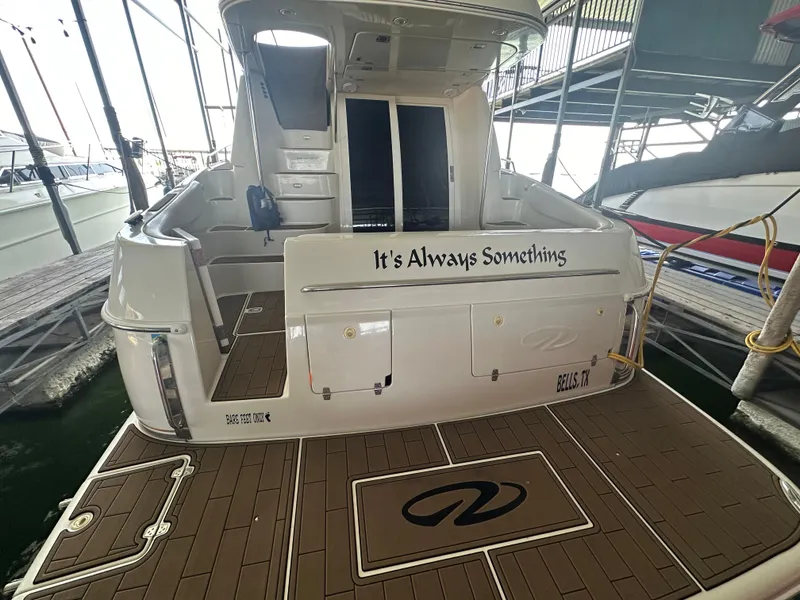 Slide: The Image of 2001 Regal Commodore 3780 yacht docked, rear view with "It's Always Something" text. - 14