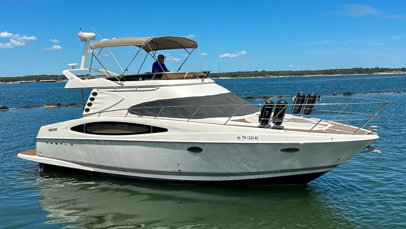 Slide: The Image of 2001 Regal Commodore 3780 yacht cruising on a sunny day. - 6