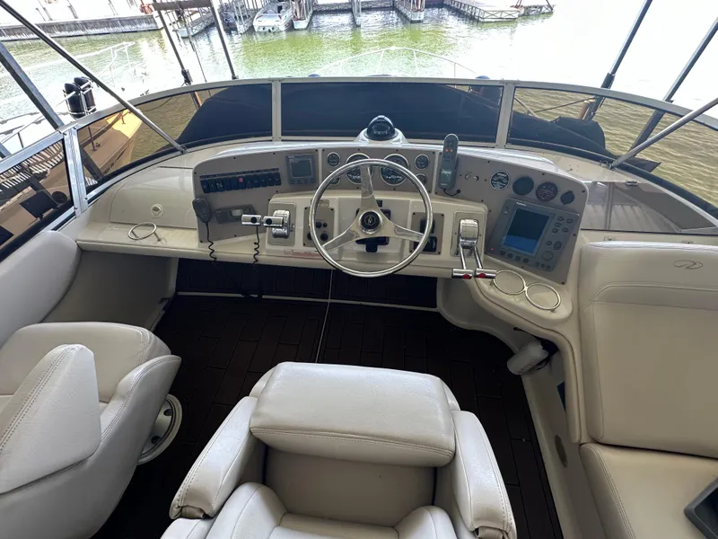 Slide: The Image of 2001 Regal Commodore 3780 yacht helm with steering wheel and navigation controls. - 16