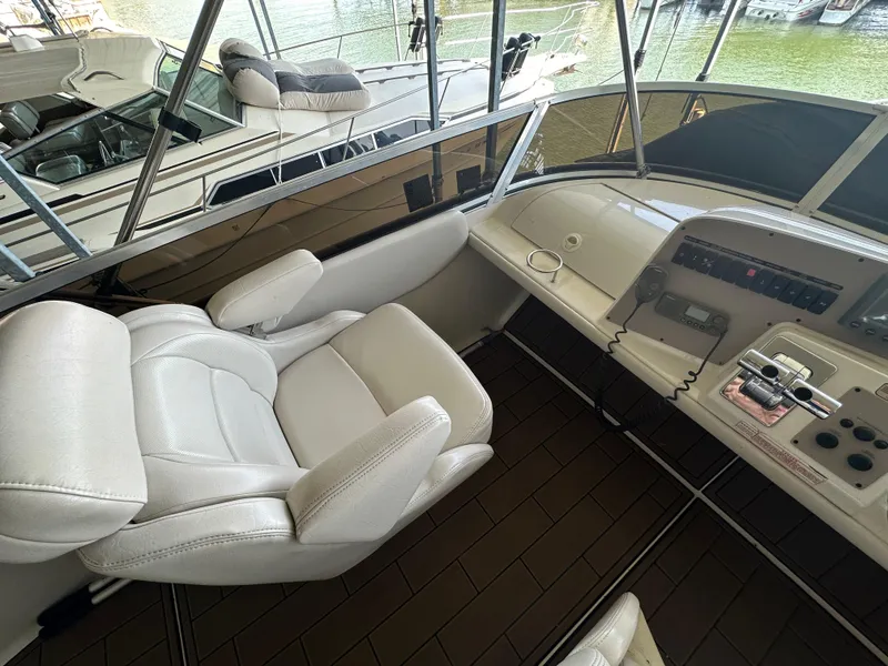 Slide: The Image of 2001 Regal Commodore 3780 helm with white captain's chair and control panel. - 21