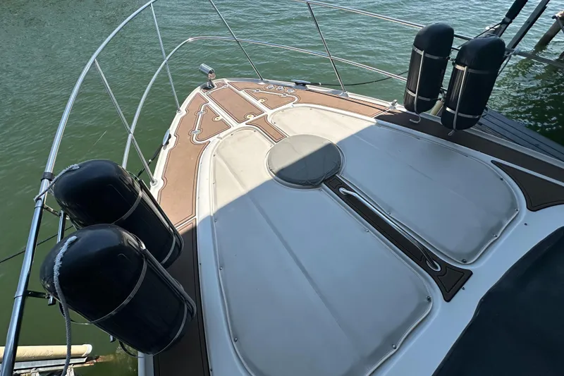Slide: The Image of 2001 Regal Commodore 3780 boat deck with fenders, docked on calm water. - 26