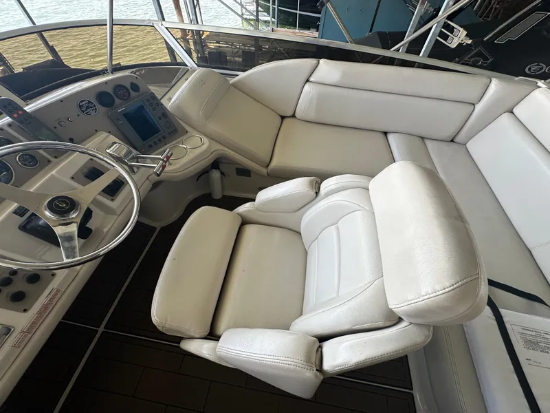 Slide: The Image of 2001 Regal Commodore 3780 helm with white leather seating and modern dashboard controls. - 20