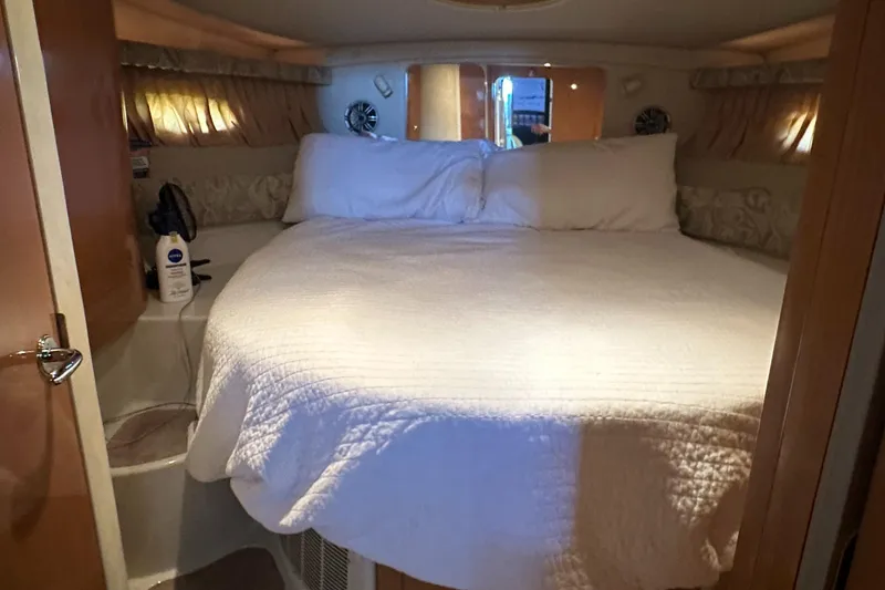 Slide: The Image of Cozy bedroom in 2001 Regal Commodore 3780 yacht with white bedding. - 43