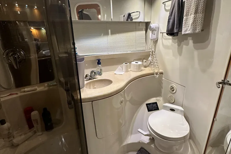 Slide: The Image of Bathroom interior of 2001 Regal Commodore 3780 yacht, featuring sink, toilet, and shower. - 46