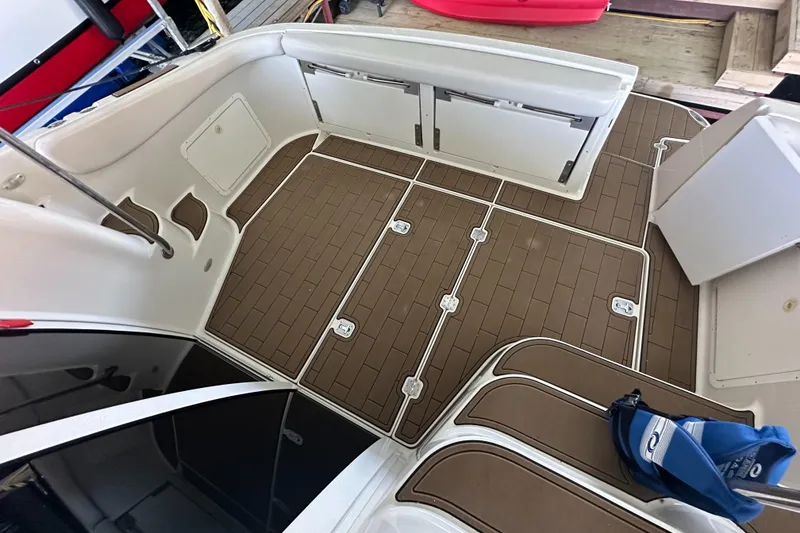 Slide: The Image of 2001 Regal Commodore 3780 boat deck with brown flooring and white seating. - 28